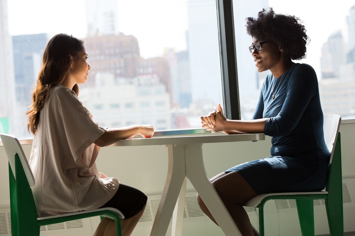 Two people in a supportive conversation, representing a therapy session